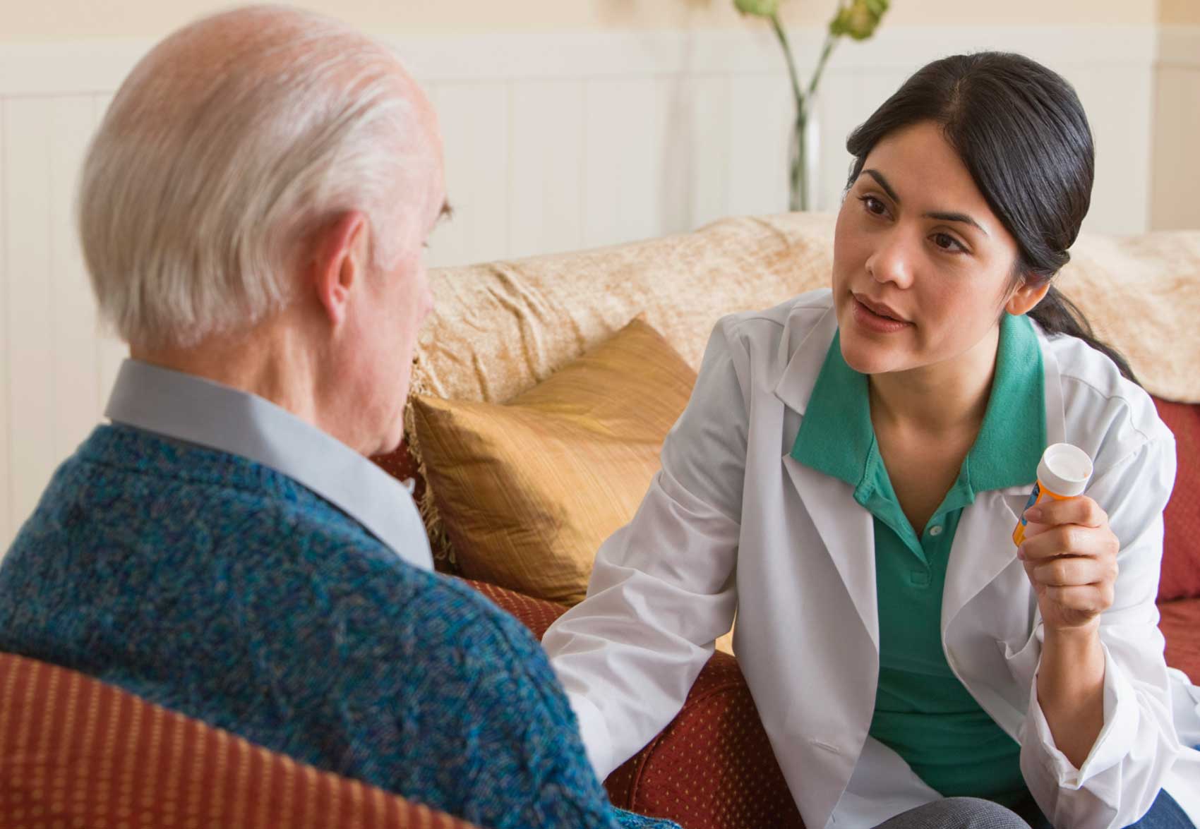 Home care professional speaking with a client at home.